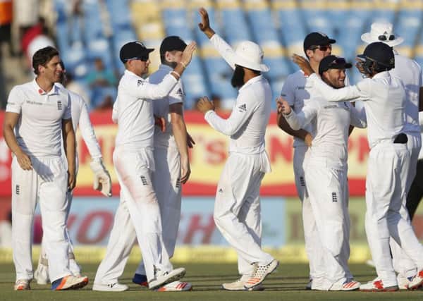 England players celebrate the wicket of Indian batsman Amit Mishra