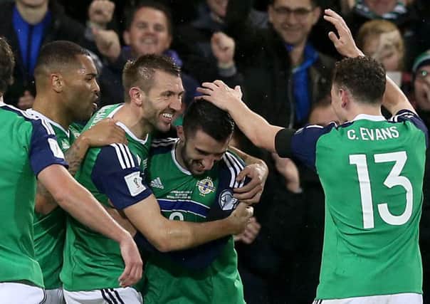 McLaughlin (centre) is congratulated by his Northern Ireland team-mates
