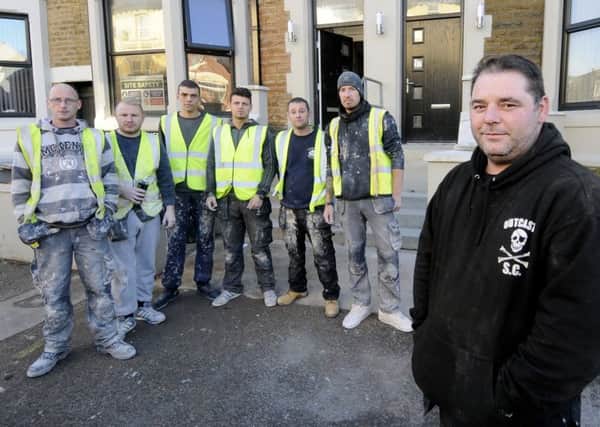 Tony Mulligan with staff who could lose their jobs after the council refused permission for flats they are building