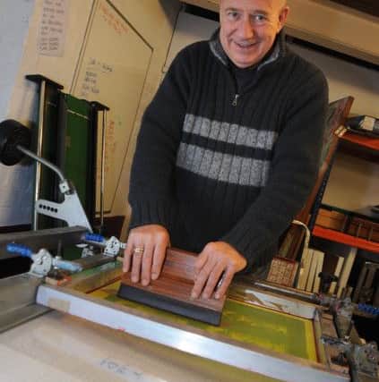 Robin pictured in his studio working on a screen print