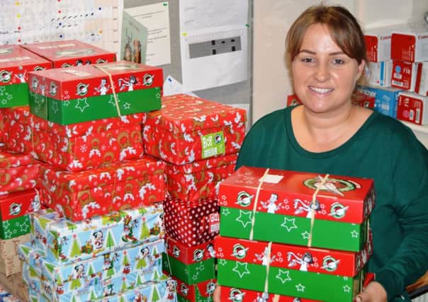 Danielle Perrett, a switchboard operator at Blackpool Victoria Hospital, with some of the shoeboxes she has collected as part of the Operation Christmas Child appeal.