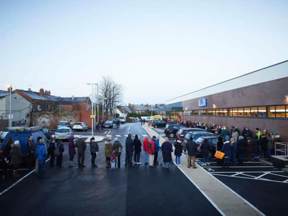 Shoppers get in line for the opening of the Aldi store in Poulton