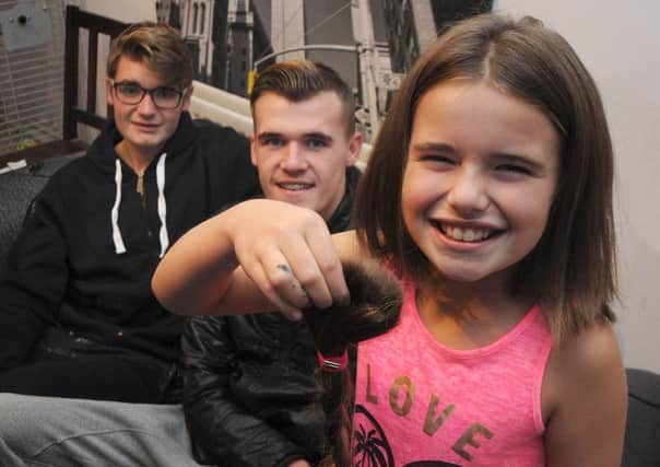 8 year-old Jessica Gray, of Queen Victoria Road in Blackpool, has had her long hair cut off to donate to cancer charities for wig-making.
Jessica is pictured with brothers Declan (right) who was treated for cancer eight years ago, and Ryan.  PIC BY ROB LOCK
29-11-2016