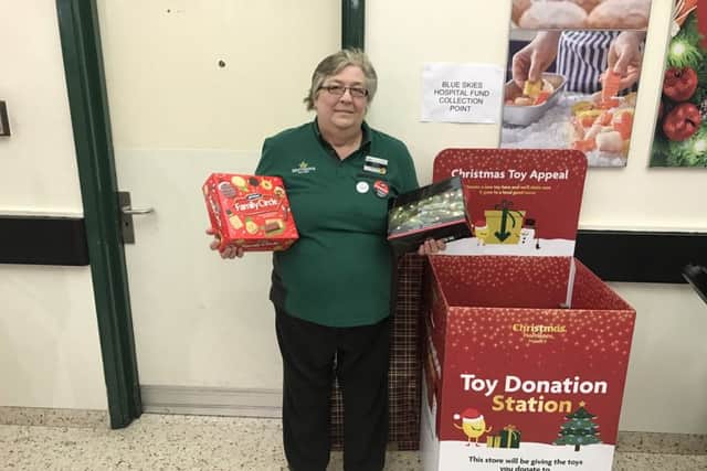Marian Copping, from Morrisons, admires the number of donations to The Gazettes Give a Gift appeal so far