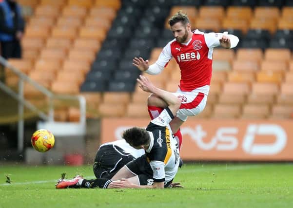 Fleetwood Town's Jimmy Ryan is tackled by Port Vale's Sam Hart