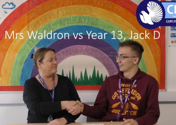 Still image from Carr Hill School's TV channel. Picture are Mrs Waldron and Jack Dinsley during the teacher challenge