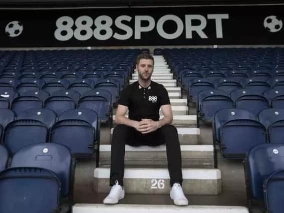 Preston midfielder Paul Gallagher in front of the new advertising boards at Deepdale