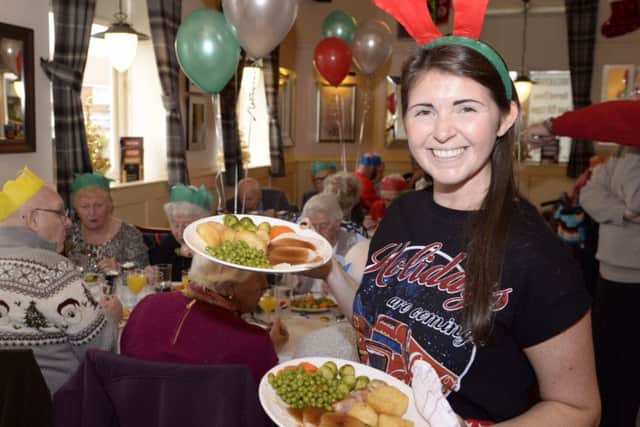 Pictures Martin Bostock. Free Christmas lunch for the local community at the Newton Arms, Staining. Gemma Wilkinson serving up the lunches.