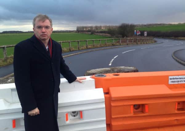 MP Mark Menzies at the long-closed Moss Road - could a funding package agreement be close?
