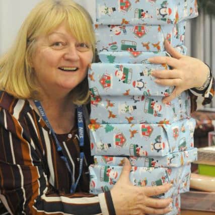 Staff and volunteers wrapping presents donated to the Give a Gift appeal at Blackpool Victoria Hospital.  Pictured is Ann Hedley from Blue Skies Hospitals Fund.