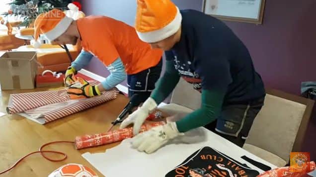 Goalkeepers Sam Slocombe and Dean Lyness attempt the wrapping challenge
