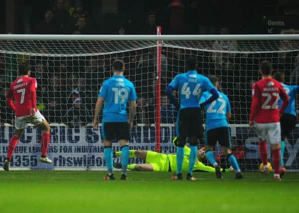 Fleetwood Town's Alex Cairns saves Swindon player Michael Doughty's penalty