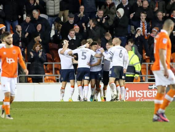 Blackpool players look on as Luton celebrate their second goal.