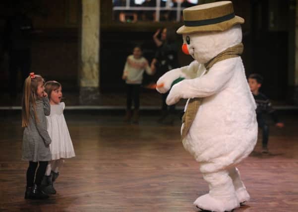 Raymond Briggs' classic Christmas animation The Snowman was shown at Blackpool Tower ballroom accompanied by an orchestra.
The snowman's dancing entrances two youngsters from the audience.  PIC BY ROB LOCK
18-12-2016