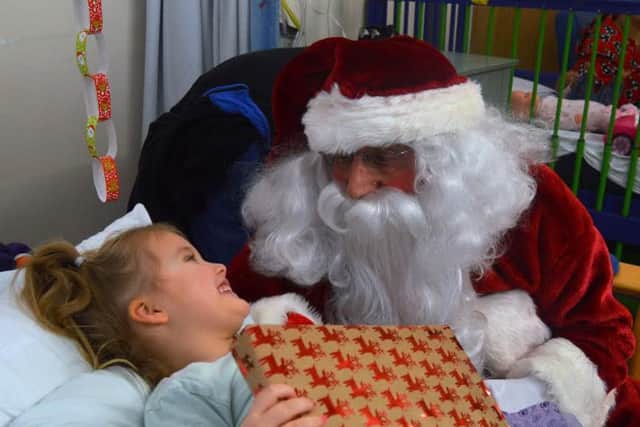 Santa Claus with Sienna Hartley, 5. Picture from Blackpool Victoria Hospital