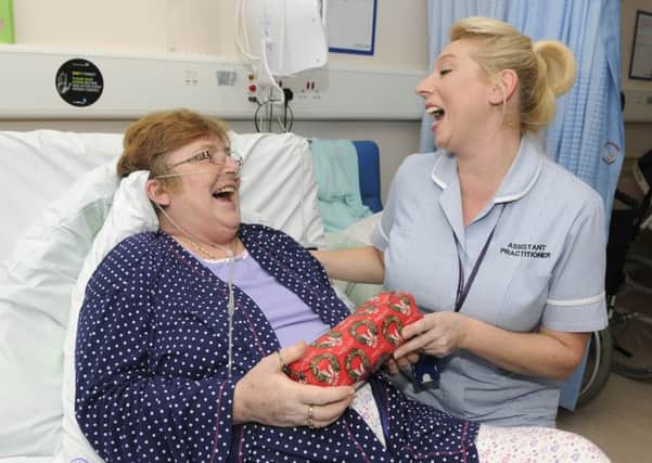Staff at Blackpool Victoria Hospital hand out Christmas presents to patients.  Assistant practitioner Denise Openshaw with patient Christine Lea
