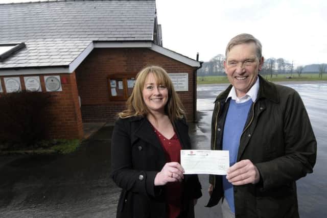 Becci Theakston from Hawdens Garstang presents a cheque to Lawrence Turner, chairman of the village hall