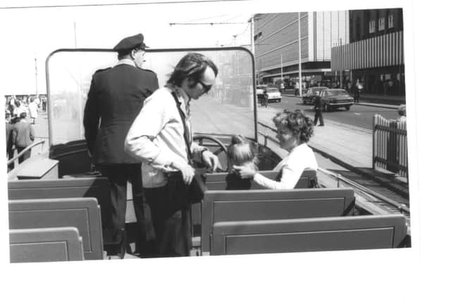 A conductor collects fares from photographer Ray Ruffell's wife and daughter Joan and Margaret on board an open boat tram July 27 1973
