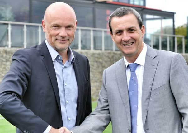 Fleetwood chairman Andy Pilley shakes hands with Uwe Rosler