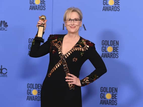 Meryl Streep poses in the press room with the Cecil B. DeMille award at the 74th annual Golden Globe Awards at the Beverly Hilton Hotel.