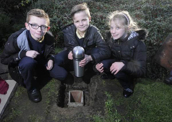 Unveiling of commemorative stone and burying of a time capsule at Oxford Square.  Pictured from Baines Endowed Primary are Lucas Burgess, Joshua Fullman and Tru Cowell.