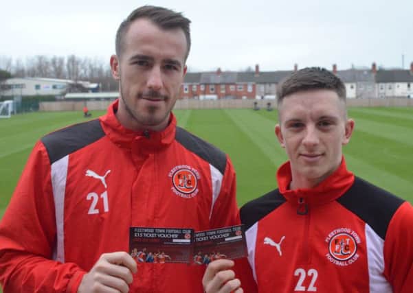 Alex Cairns and Ash Hunter show off the new ticket voucher