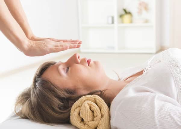 A woman taking part in Reiki healing exercise