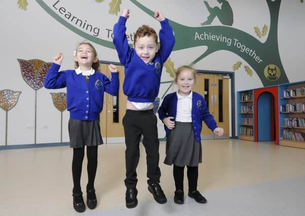Mereside Primary pupils celebrate becoming part of the Fylde Coast Academy Trust.  Pictured are Tayla Hawes, 6, Syd Jewell-North, 5 and Skyla Tolmie, 4.