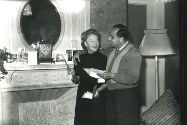 Gracie Fields and her husband Boris Alperovici looking at their Christmas cards in their suite at the Imperial Hotel, Blackpool on Christmas Eve 1955.