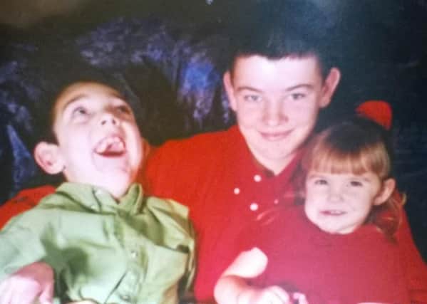 Adam with his brother and sister