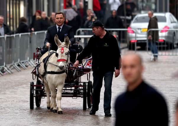 David Walliams arrives on a cart pulled by a donkey