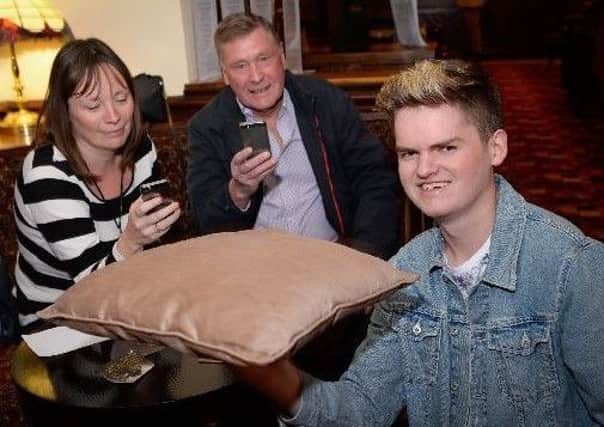 Thomas Senior attempts to set a world record at the Boot and Shoe, watched by Alison Trippier and Mike Kirkham