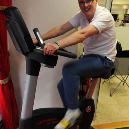 Ged on an exercise bike on a charity fundraiser