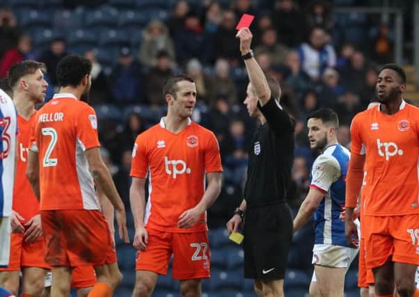 Blackpool defender Kelvin Mellor is shown a red card