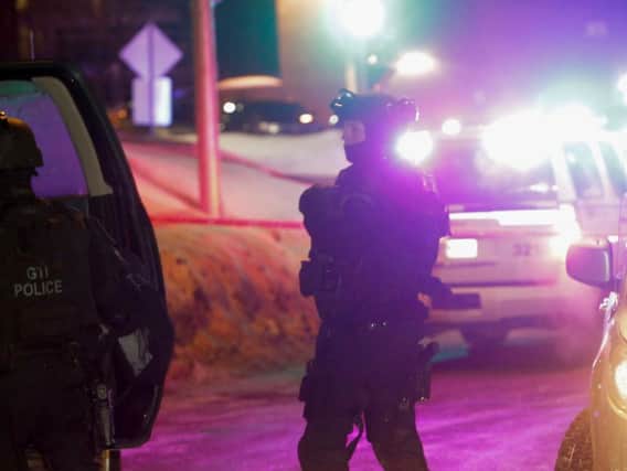 Police survey the scene after deadly shooting at a mosque in Quebec City, Canada