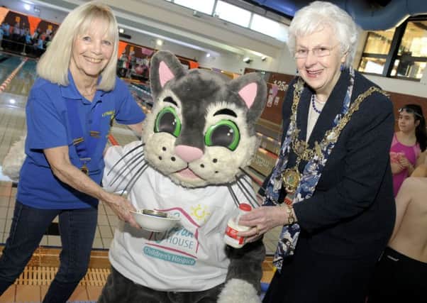 Brian House mascot Hospuss is given a treat of a tin of salmon and a
saucer of milk by Fylde may Coun Christine Ackroyd and LSA Lions president Eileen Skelly at the swimarathon held at St Annes YMCA Pool