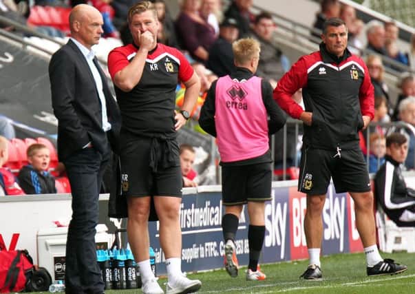 Fleetwood Town Head Coach Uwe Rosler (left) and then Milton Keynes Dons manager Karl Robinson exchange words on the touchline