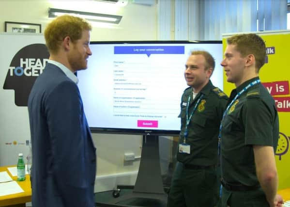 Prince Harry (left), with Dan Farnworth and Rich Morton from the North West Ambulance Service