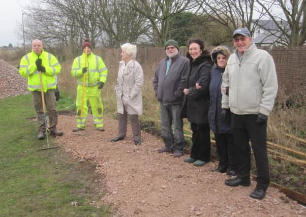 Members of the Friends of Blackpool Road North Playing Fields, St Annes, with workmen at the Health Path being constructed at the playing fields thanks to Â£12,000 from the Tesco Bags of Help scheme