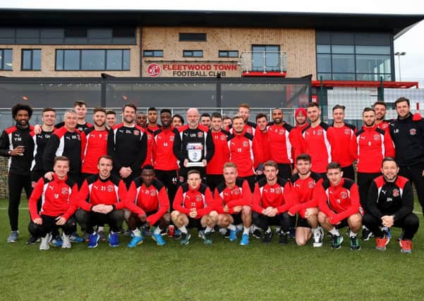 Manager of the month Uwe Rosler with his players and staff