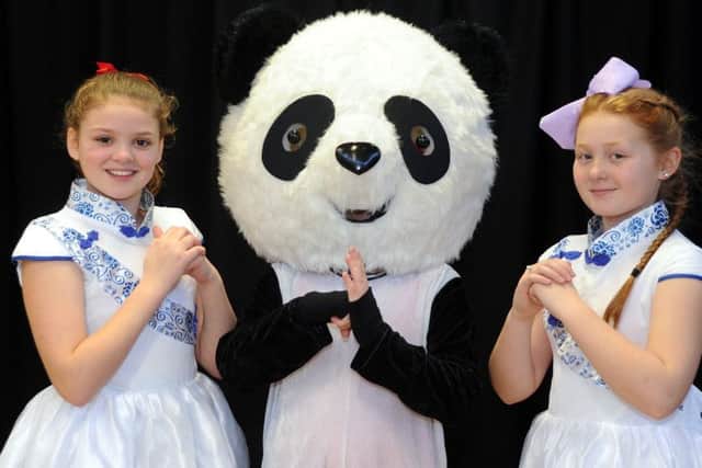 Briony Singer (left) and Ellie Brook pose with a Giant Panda