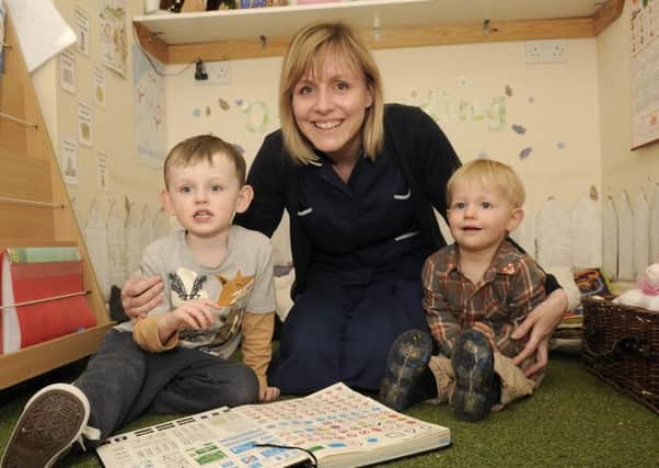 Staff and children from Layton Hill Nursery in Cleveleys celebrate after being rated outstanding in an Ofsted report.  Manager Melanie Williams with Oliver Spencer, 3 and Thomas Armstrong, 1.