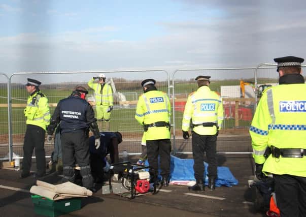 Police removing six locked-together protesters at the Preston New Road fracking site at Little Plumpton