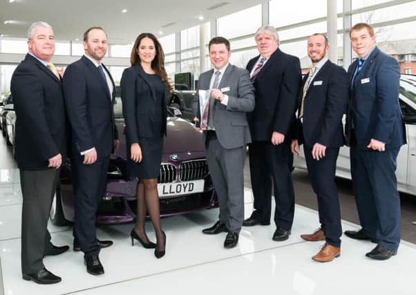 Mark Powell, head of business at Lloyd BMW Blackpool, pictured with the BMW Retailer of the Year award, alongside his team