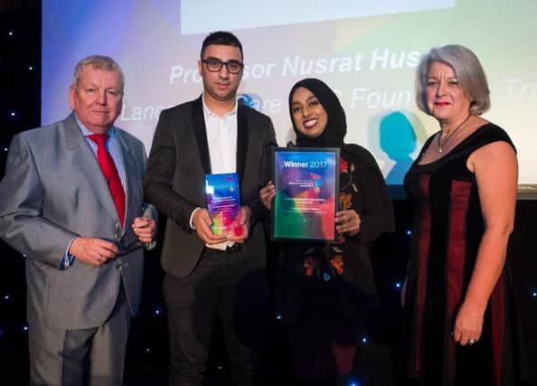 Nusrats colleagues, Nadeem Gire and Farah Lunat, receive Nusrat's award on his behalf
