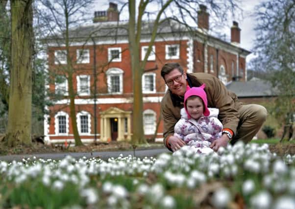 Oliver Bagot  and daughter Isabelle, five, admiring the snowdrops at Lytham Hall
