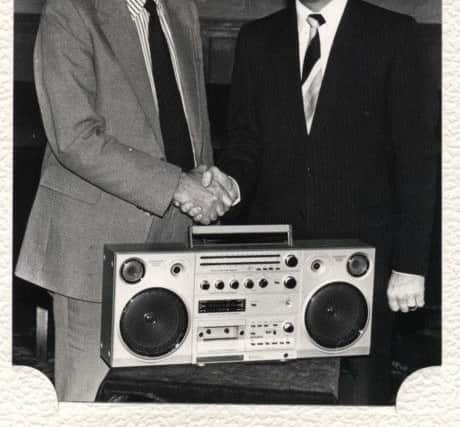 Leslie Heyes, leaving the Tower Company in 1982, receiving the company's farewell gift from general manager Donald Gledhill