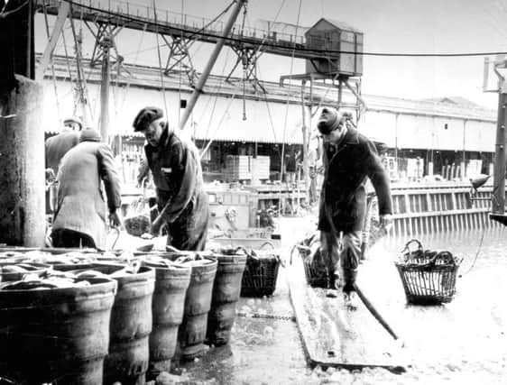 Dockers unloading a catch of fish at Fleetwood dock, in 1989