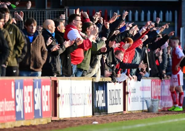 Fleetwood Town fans celebrate at the end of the game