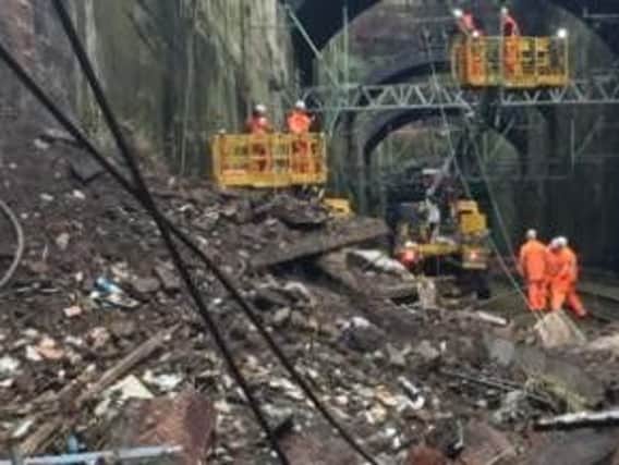 A section of trackside wall collapsed sending 200 tonnes of debris across the four lines